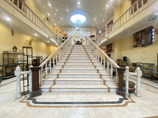 Grand marble staircase inside the Uday Crafts showroom facility
